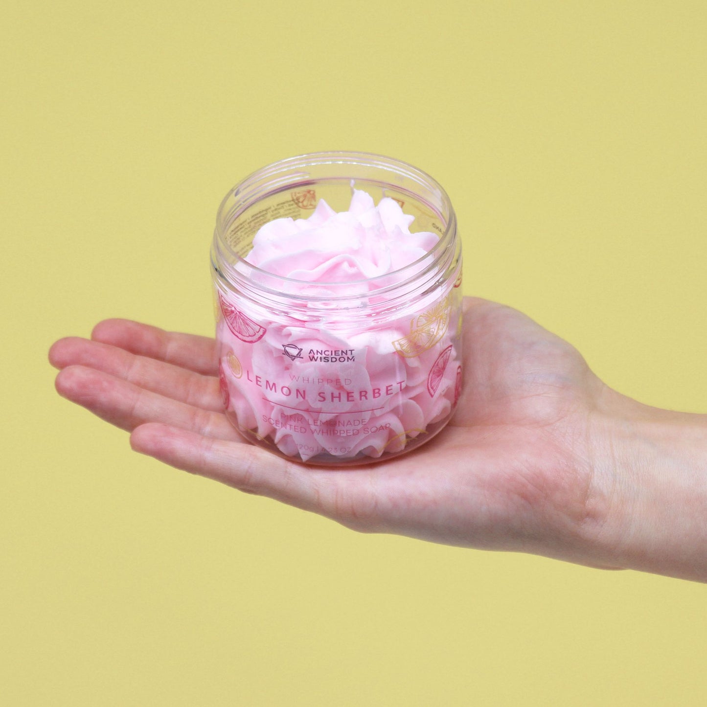 Pink Lemonade Whipped Soap 120g in a clear jar, pink lemon sherbet scent, held in a hand