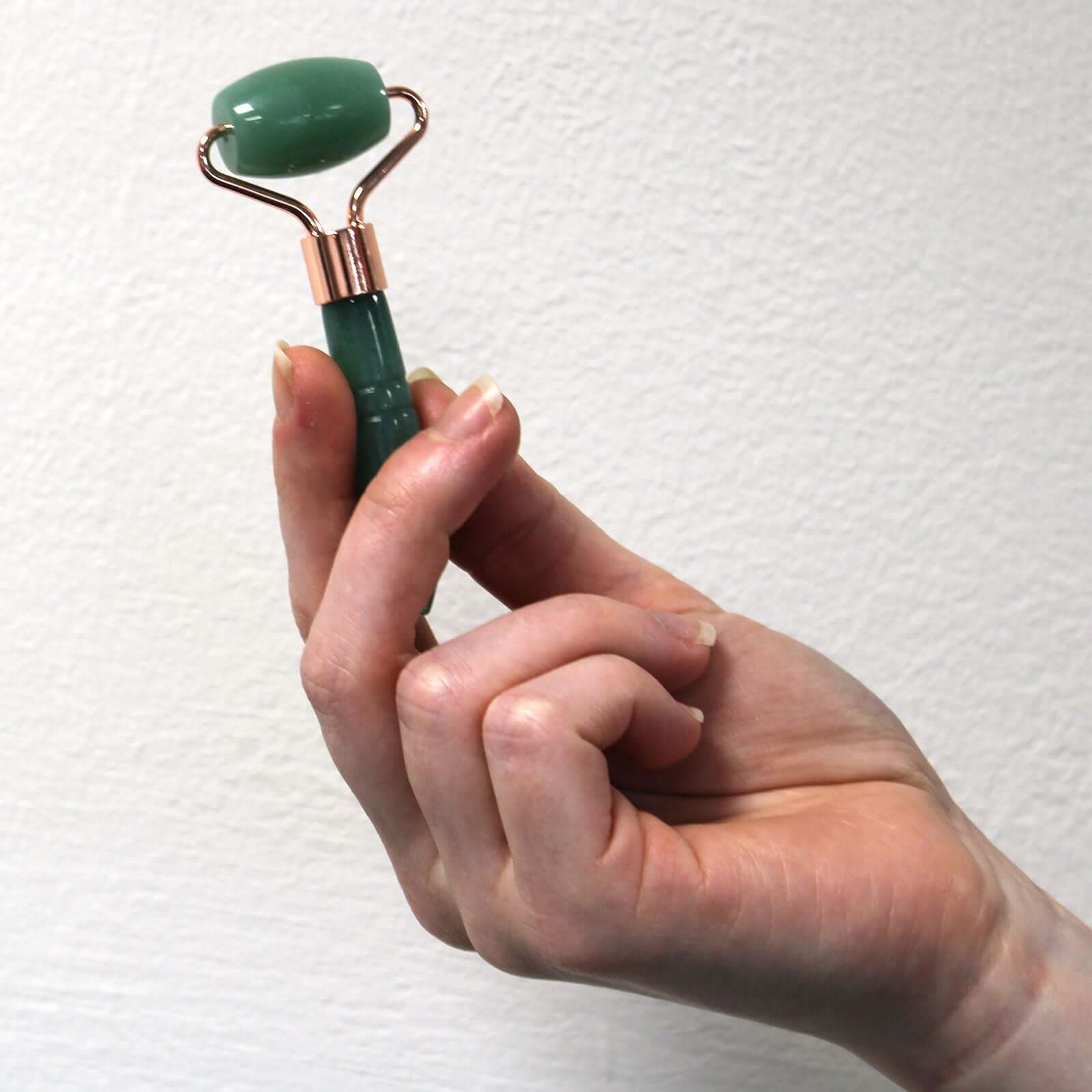 Gemstone Mini Jade Roller For Facial Massage Travel Size held in hand, showcasing its compact and stylish design.