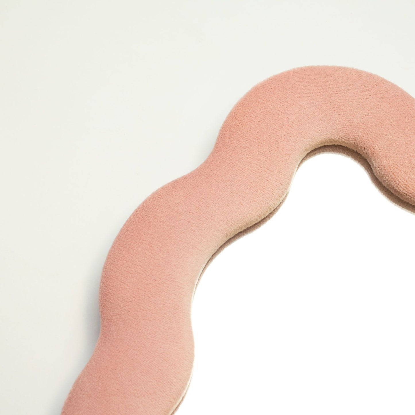 Pink foam roller on a light gray background