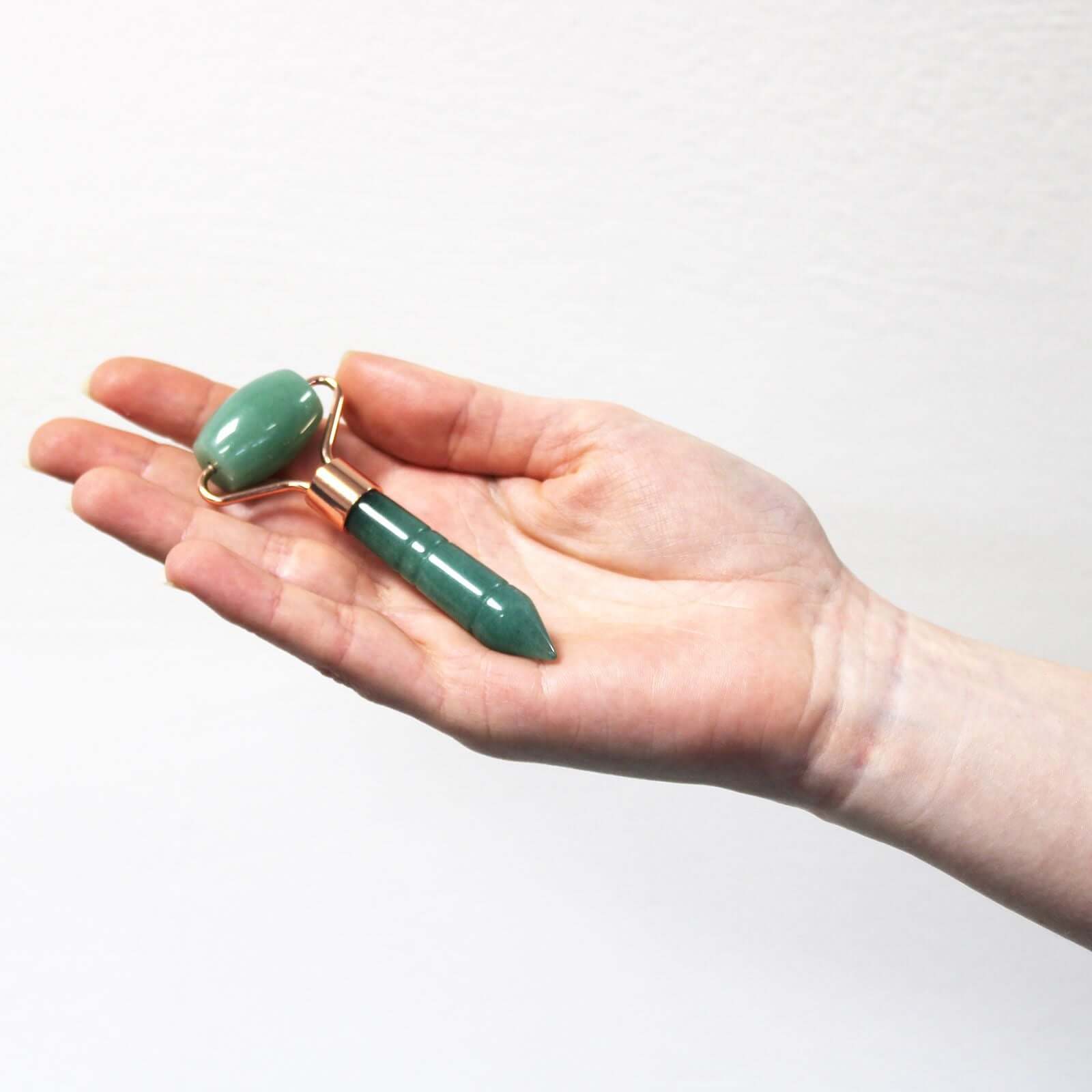 Gemstone Mini Jade Roller For Facial Massage Travel Size held in hand, showcasing its compact design and jade properties.