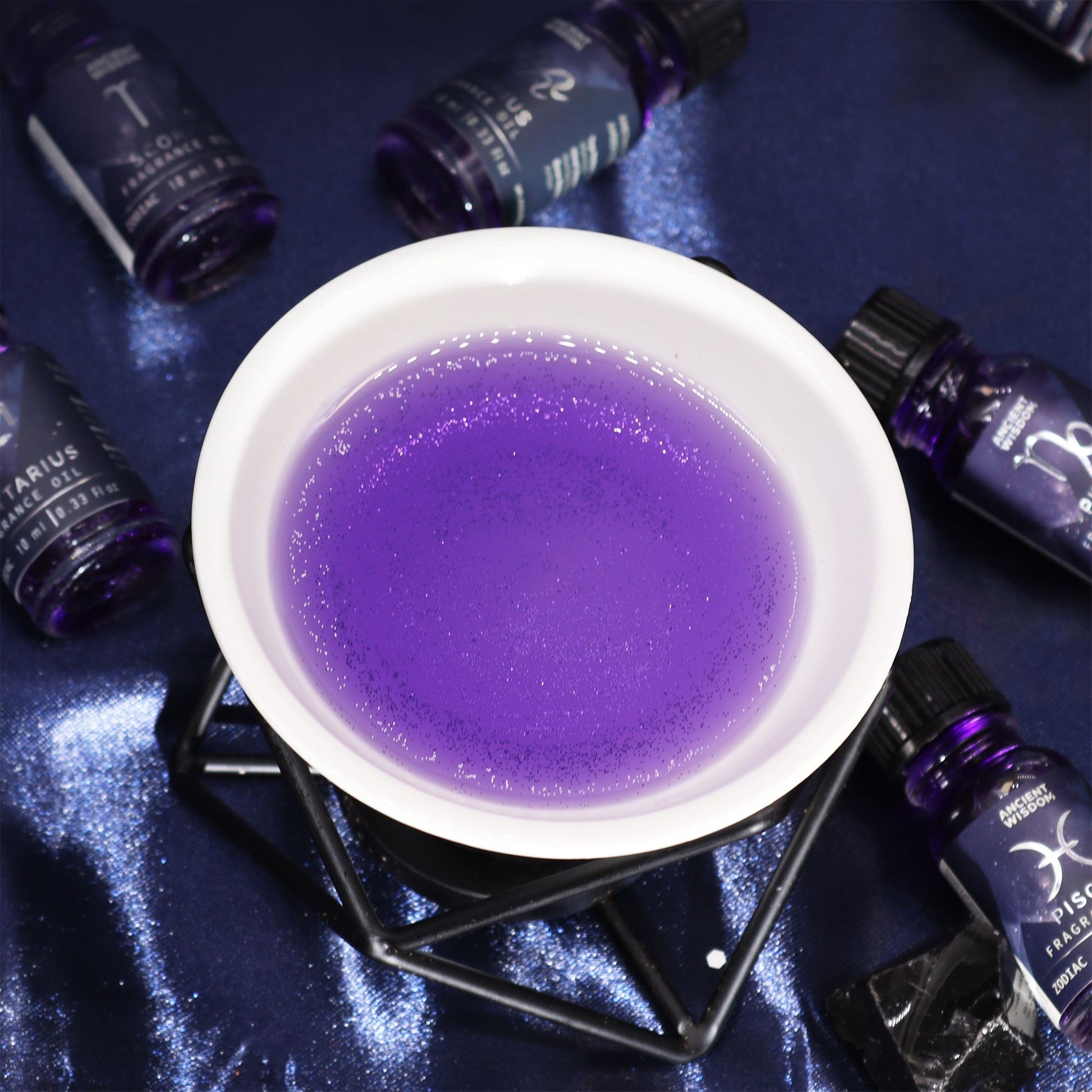 Zodiac Fragrance Oil 10ml - VIRGO in a bowl, featuring dark oil with bio glitter for a celestial essence.