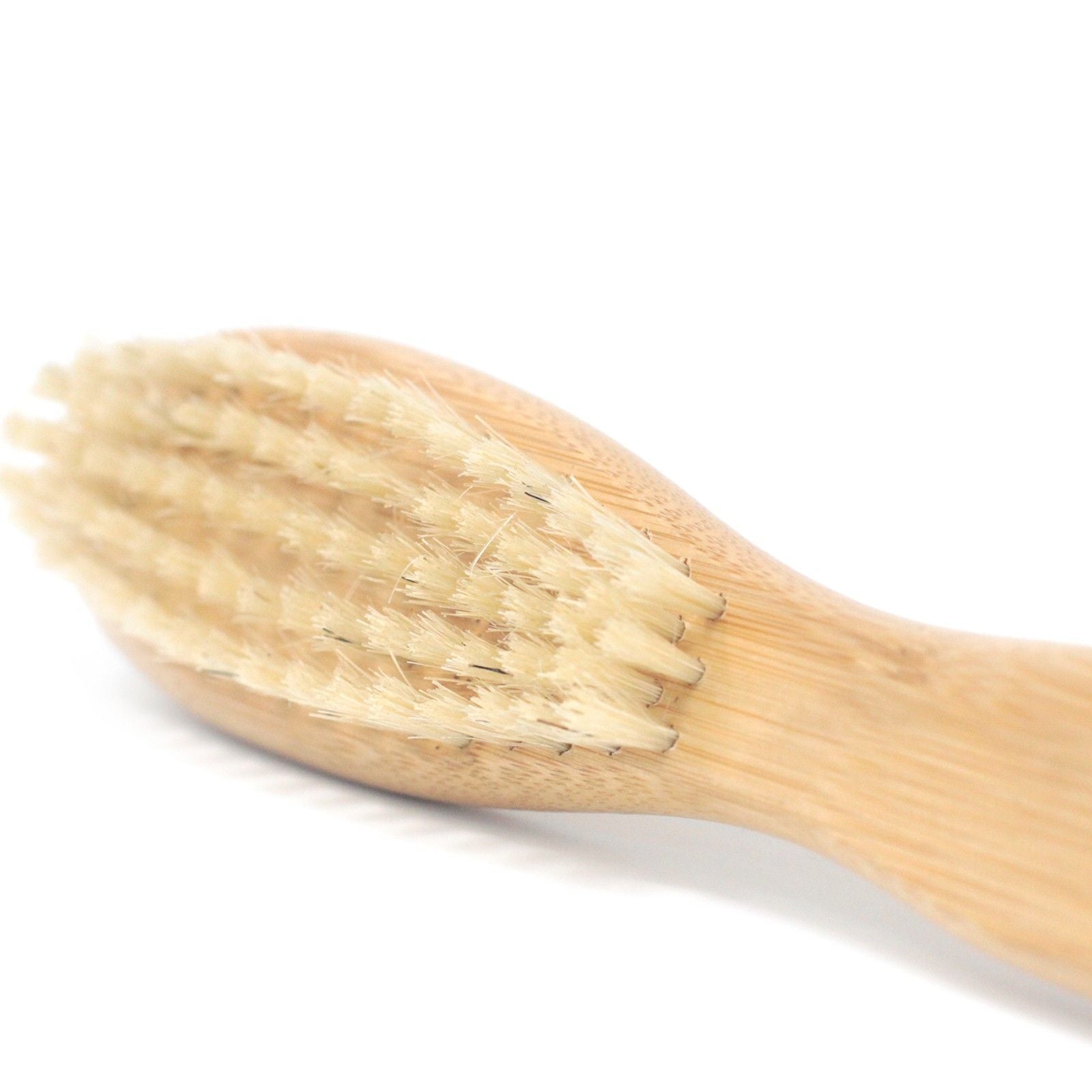 Close-up bamboo beard brush with boar-hair bristles for beard grooming