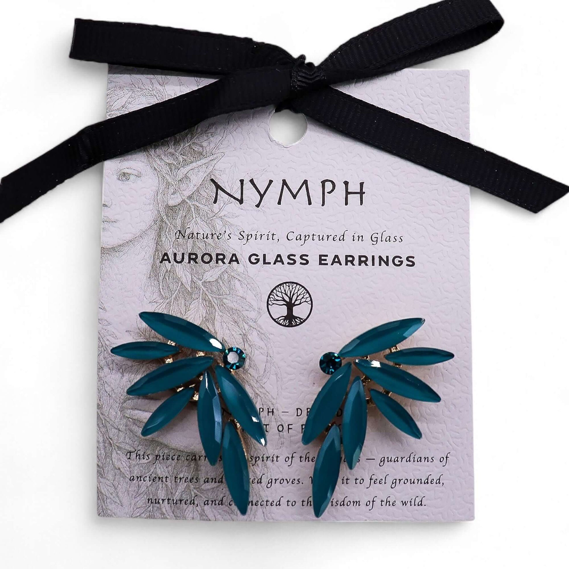 Teal green vintage glass fairy earrings on lavender card with black ribbon.