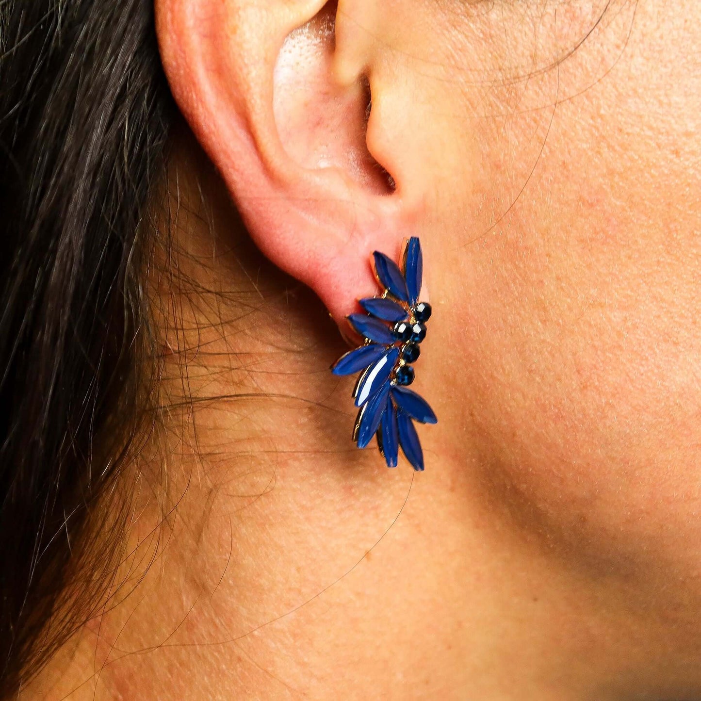 Royal Blue Vintage Glass Fairy Earrings With Leaf Motif worn on earlobe, showcasing vintage design and ocean hue.