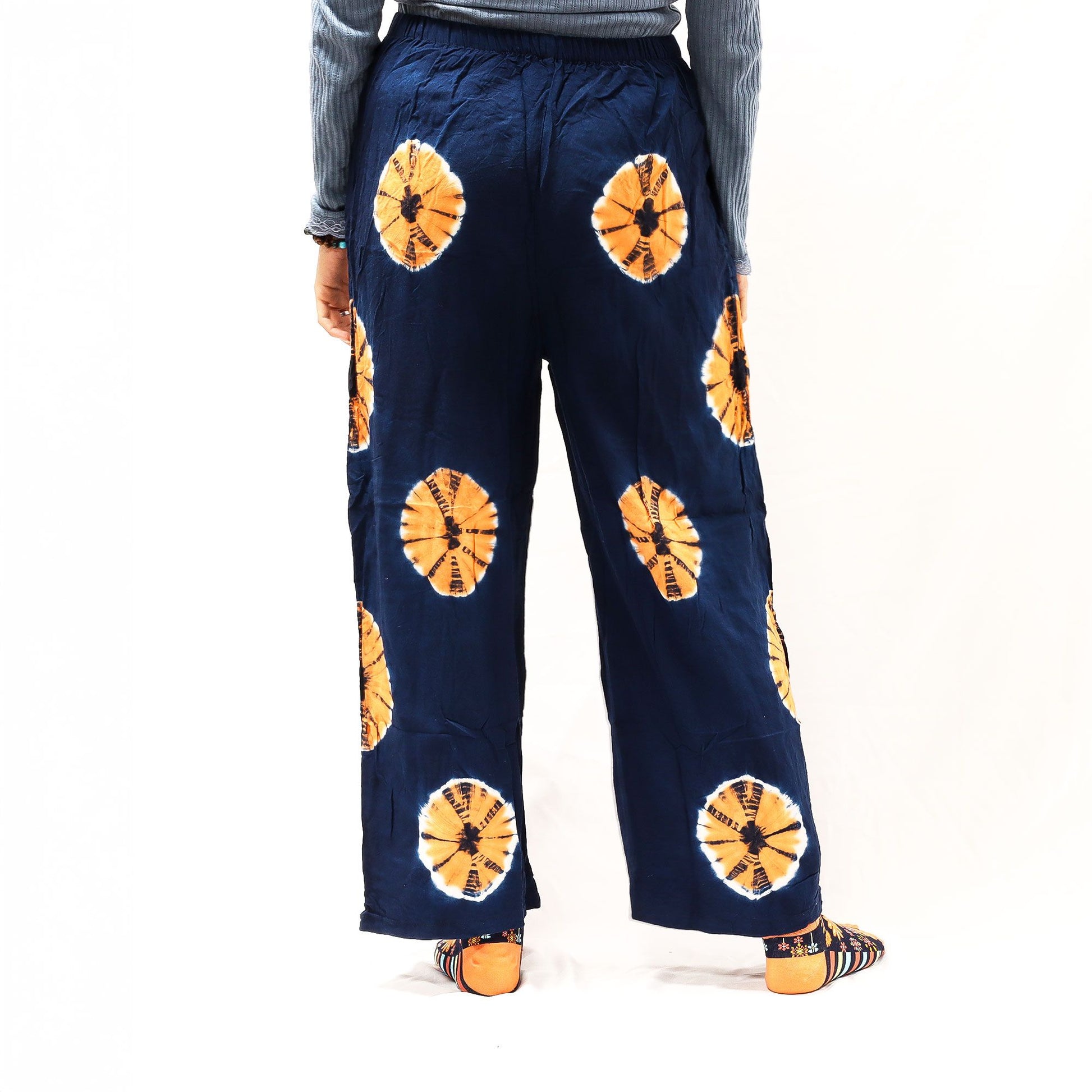 Medium navy blue Japanese-style lounge pants with orange circular tie-dye motifs; linen-rayon blend.
