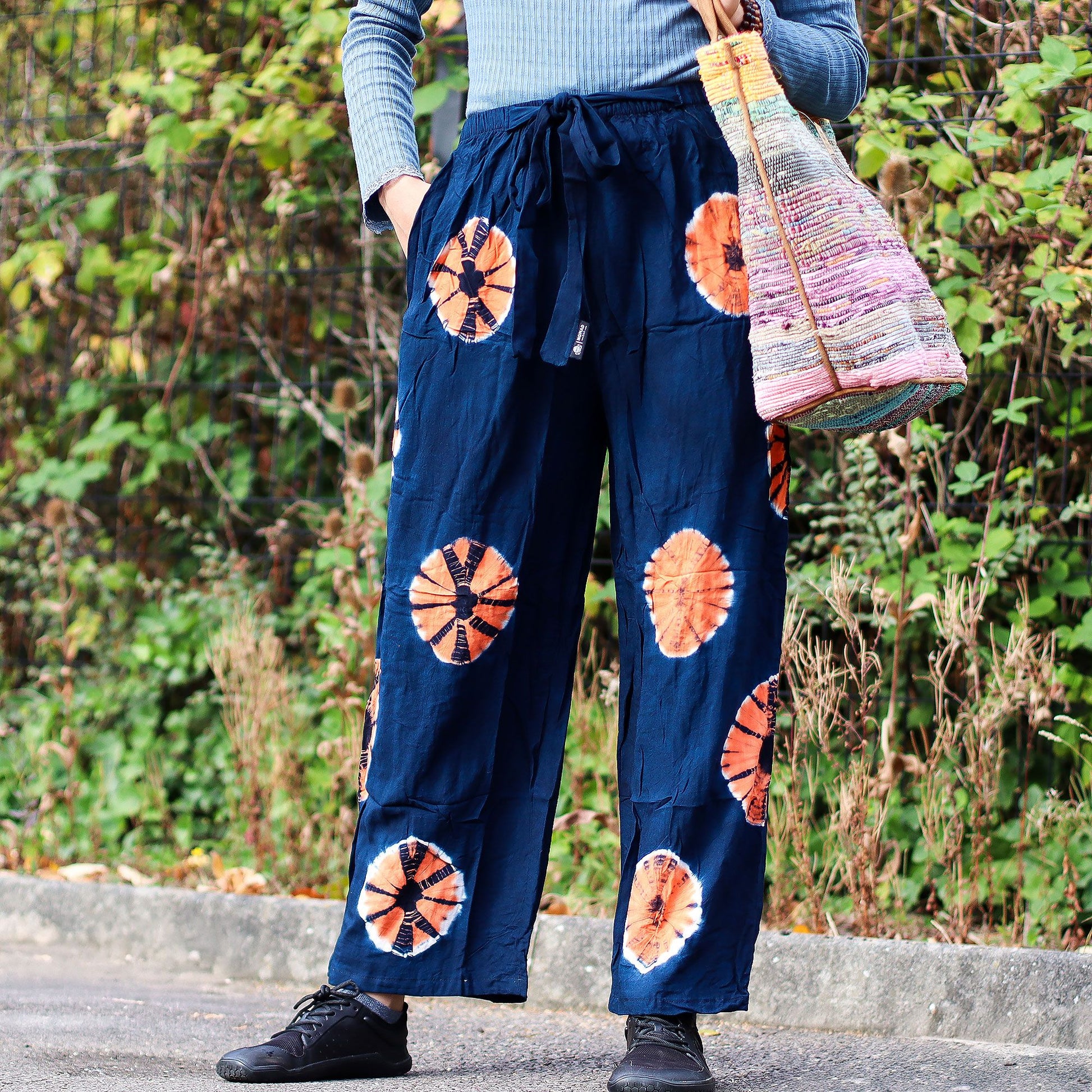 Navy Japanese-style wide-leg lounge pants with orange tie-dye circles and a drawstring waist.