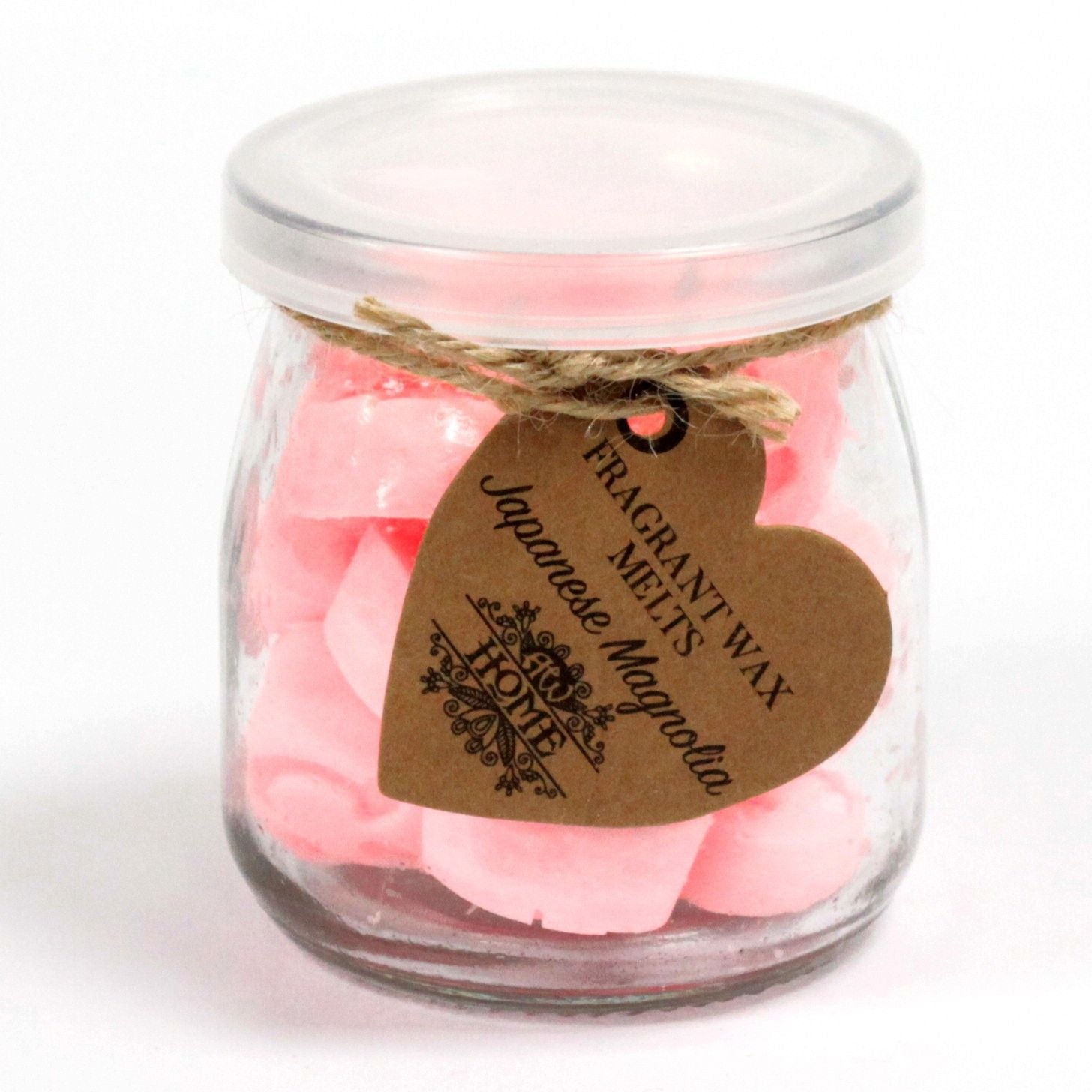 Glass jar with pink heart-shaped soy wax melts, tied with twine; brown tag reads Japanese Magnolia.