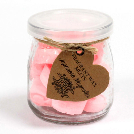 Glass jar with pink heart-shaped soy wax melts, tied with twine; brown tag reads Japanese Magnolia.