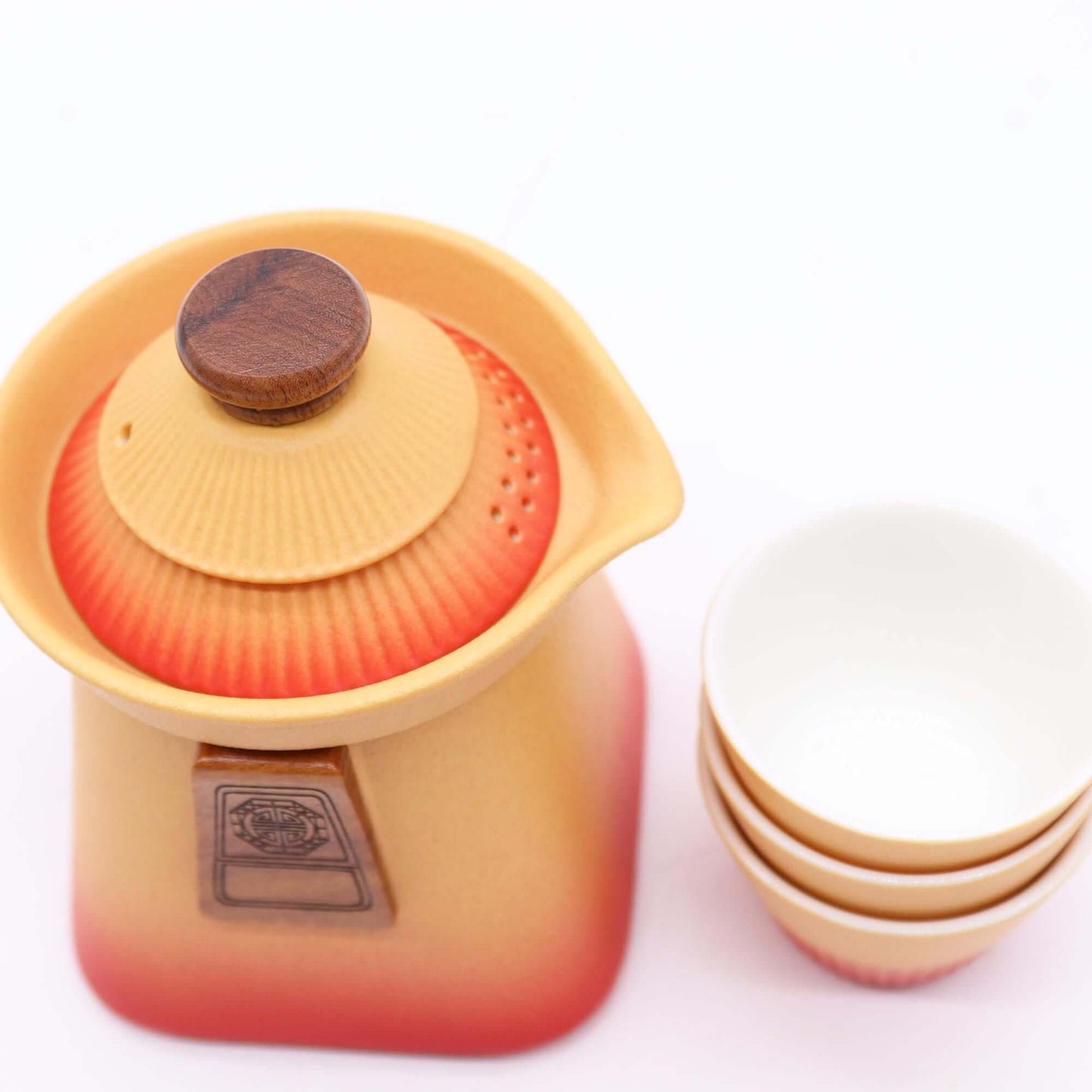 Temple Teapot Set & Three Cups - Orange Earth, featuring a ceramic teapot and three cups in artistic design.