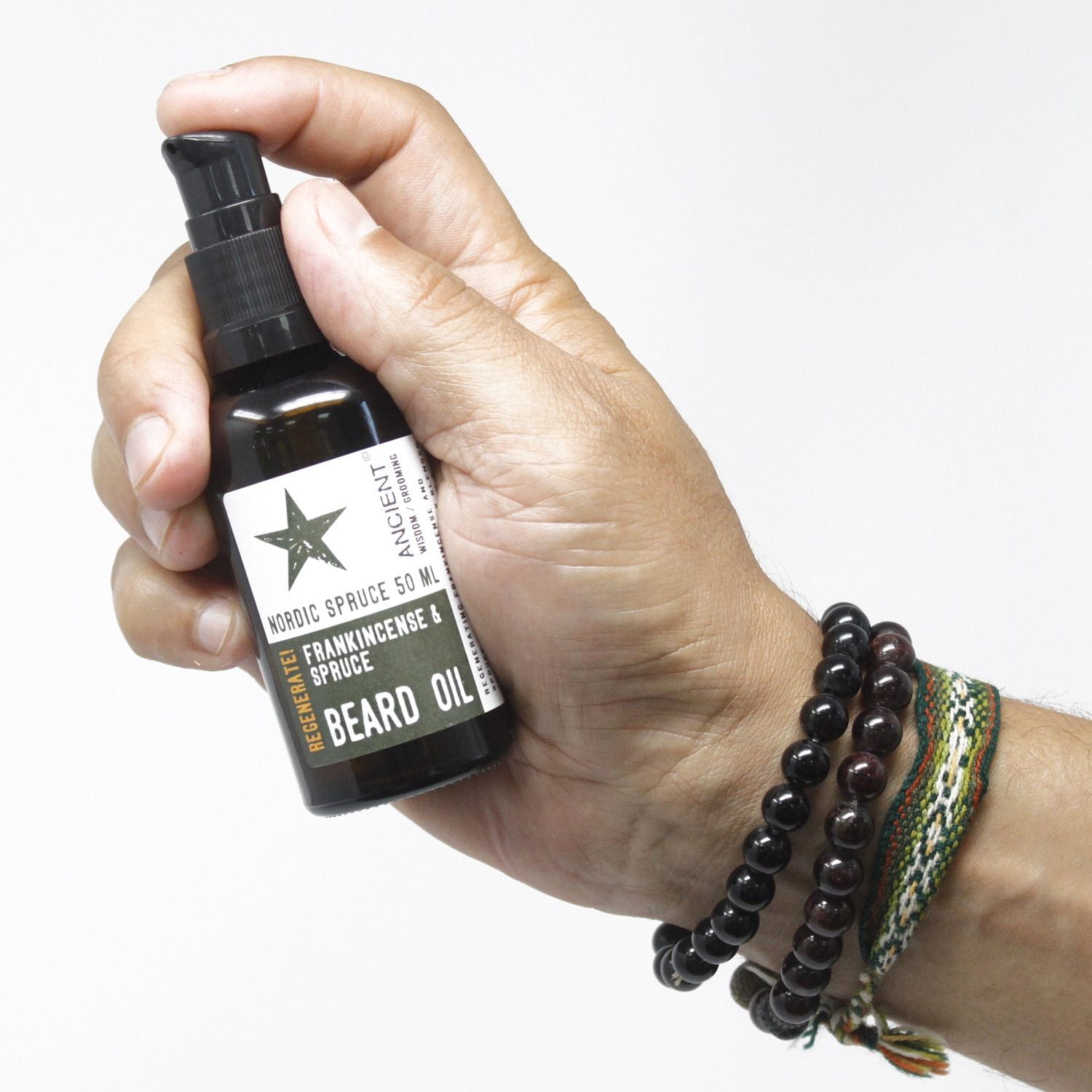 Hand holds 50ml beard oil bottle, Viking Musk Cleanse, citrus orange and sandalwood scent with coconut and jojoba oils.
