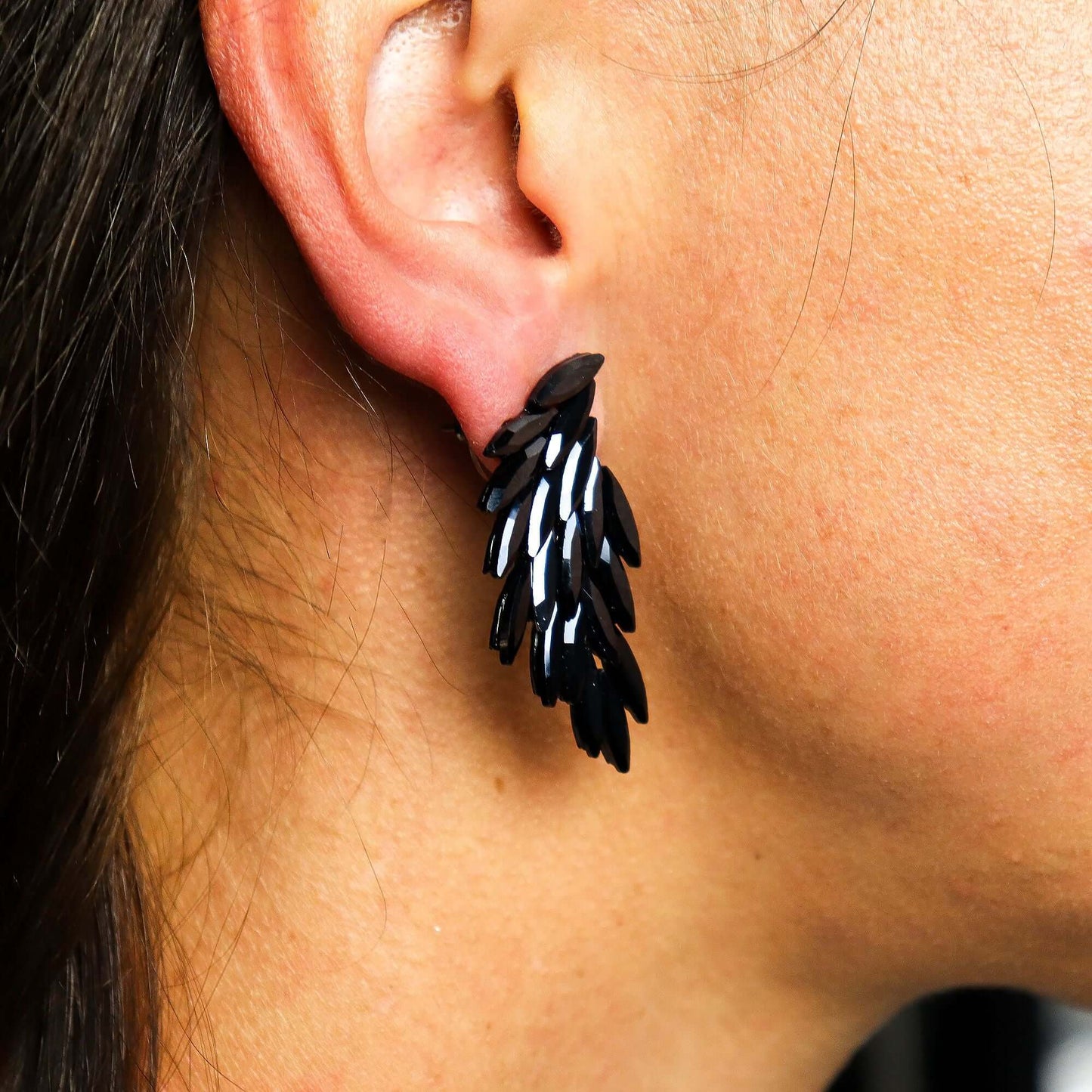 Jet Black Vintage Glass Angel Wing Earrings Stainless Steel worn on the ear showcasing their elegant design.
