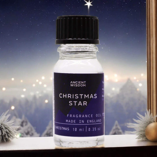 Christmas Star Fragrance Oil 10ml Festive Elegant Holiday Scent in a bottle with winter scenery behind.