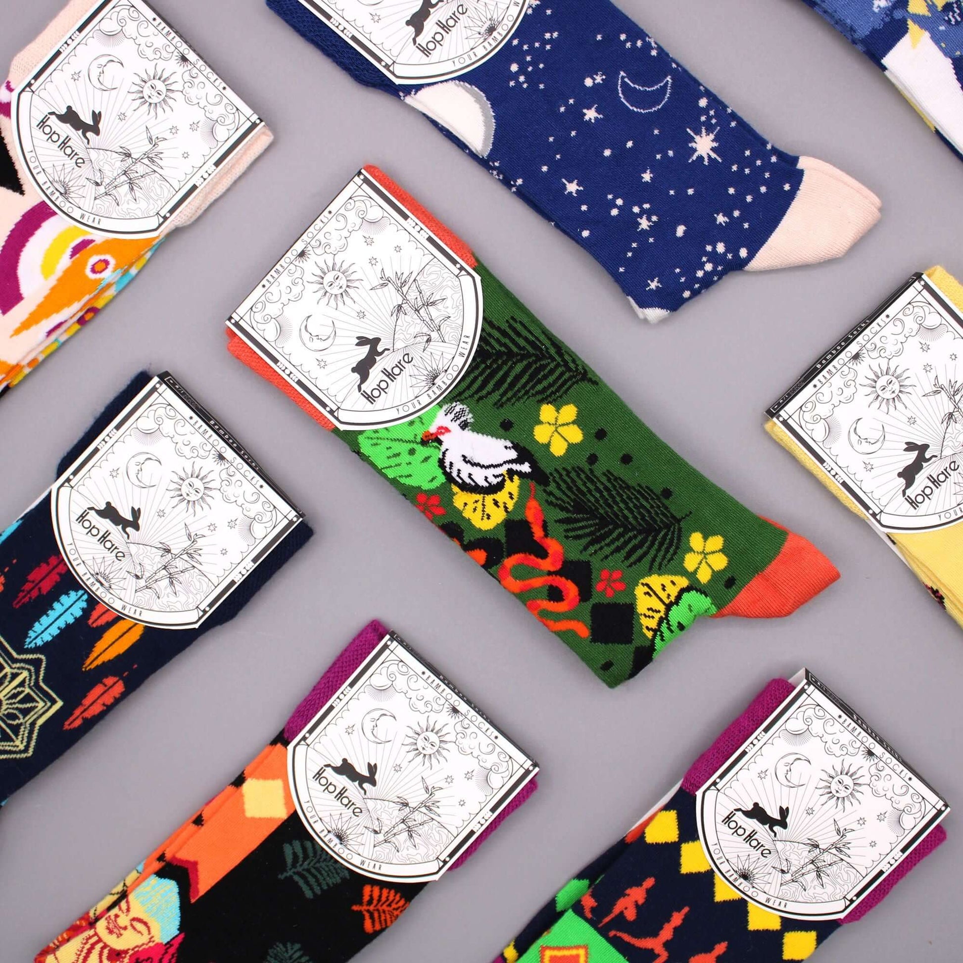 Hop Hare Bamboo Socks S/M - Ying Yang in colorful patterns arranged on a gray surface.