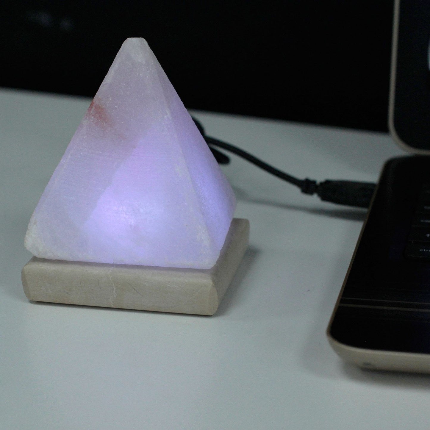 Quality USB Pyramid WHITE Salt Lamp - 9 cm (multi) on a desk with soft purple light.