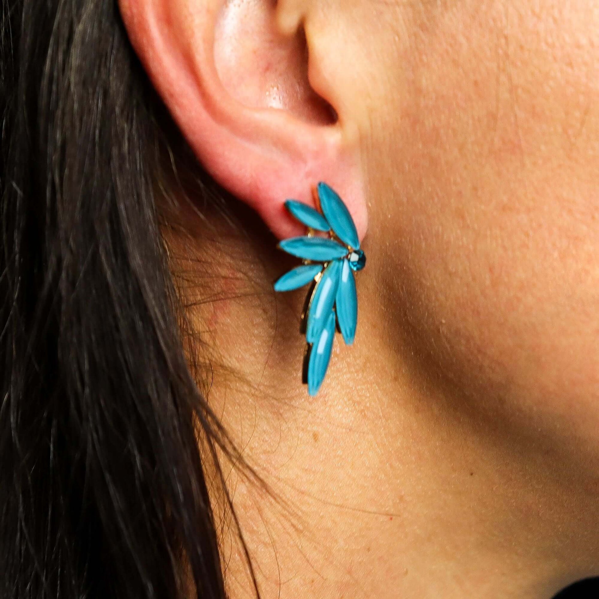 Teal green vintage-glass fairy-inspired earrings with leaf-shaped stones worn on the ear.