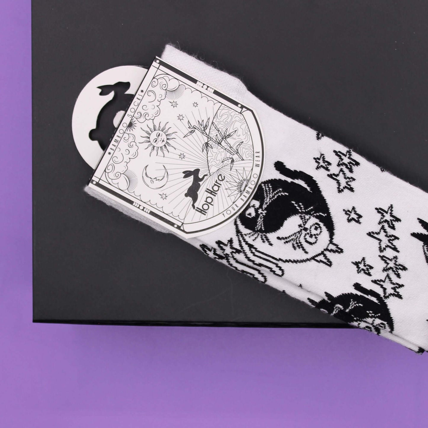 Hop Hare Bamboo Socks S/M - Ying Yang displayed with packaging against a purple background.