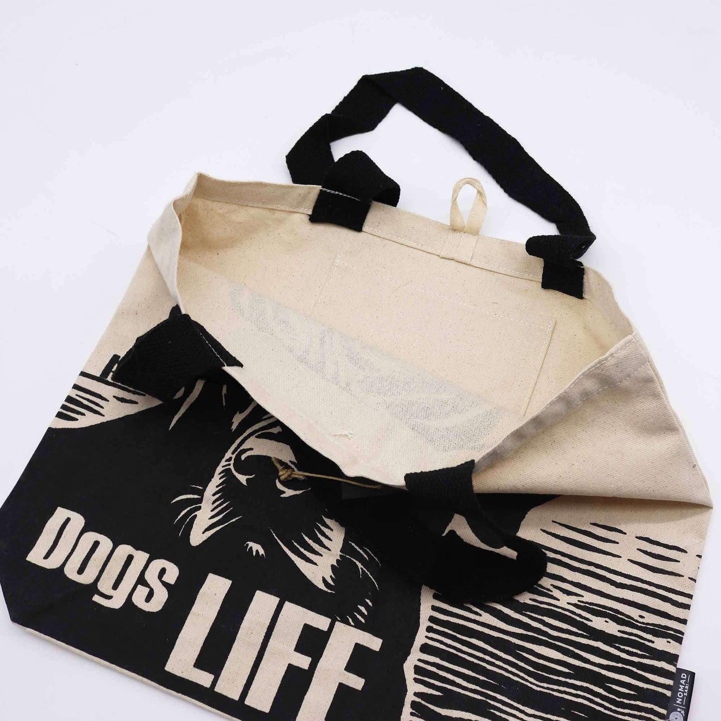 Inside view of the Iconic Classic Tote Bag - It's a Dogs Life - White 10oz with black handles and unique design.