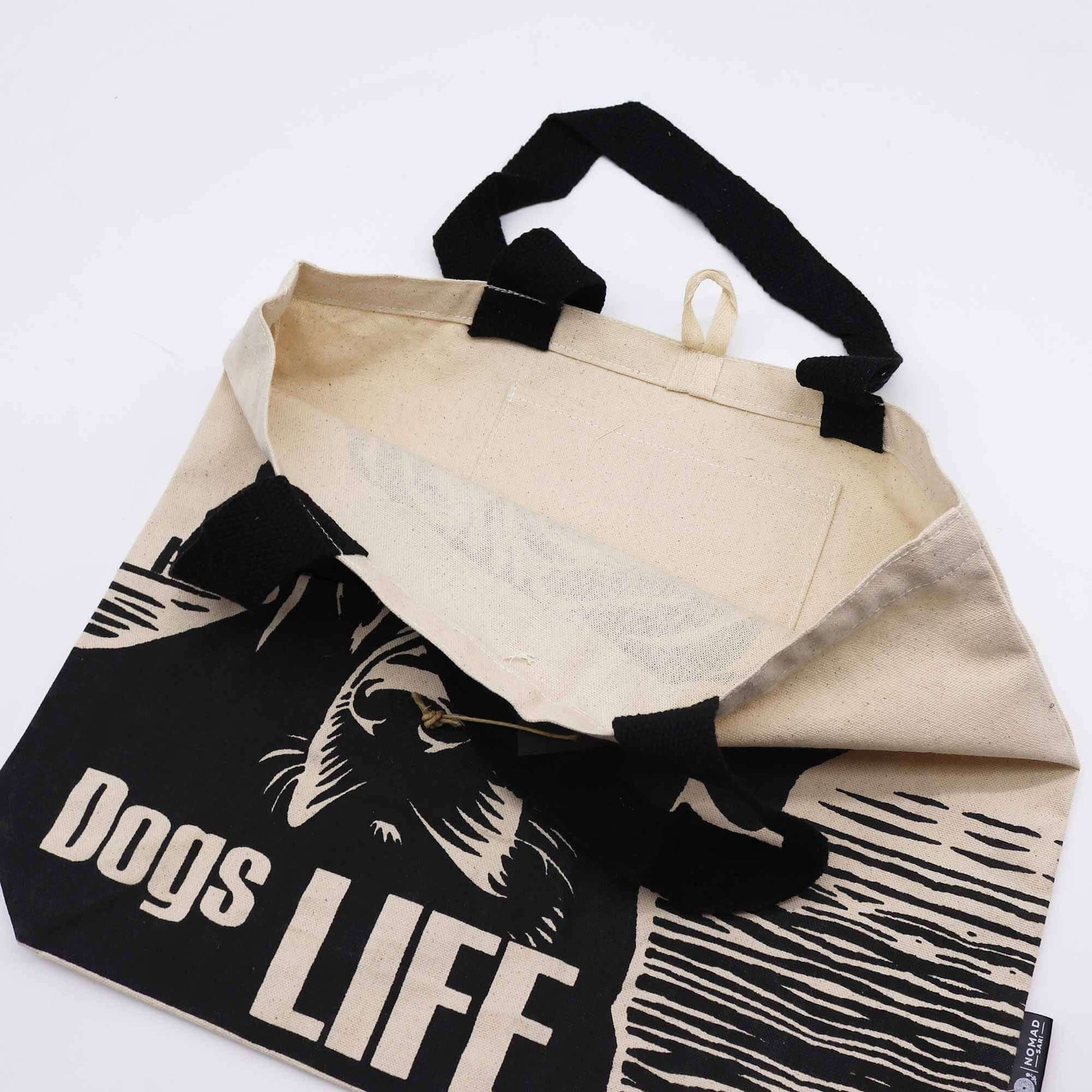 Inside view of the Iconic Classic Tote Bag - It's a Dogs Life - White 10oz with black handles and unique design.