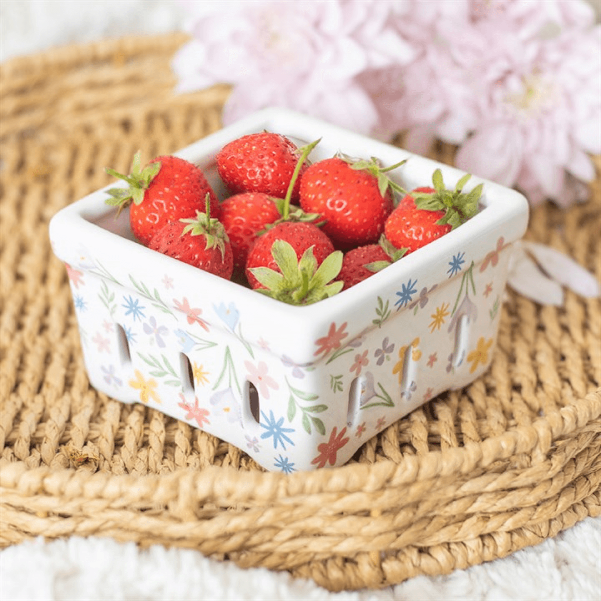 Spring Floral Print Ceramic Berry Basket filled with fresh strawberries on a woven mat.