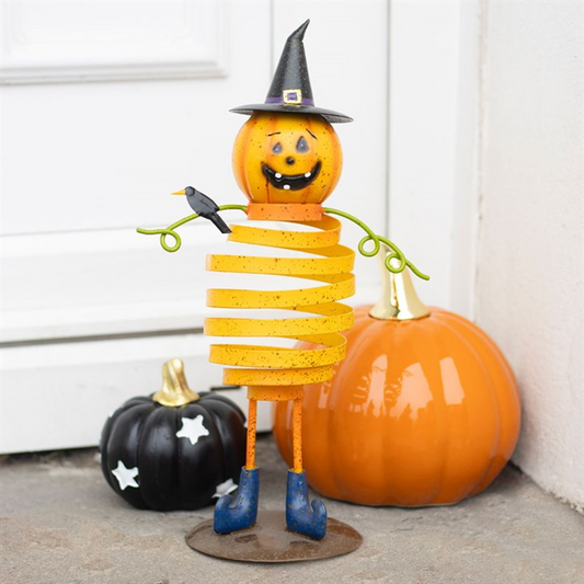 Orange metal pumpkin man ornament with spring body, 28.5cm tall, witches hat, wire arms, blue boots.