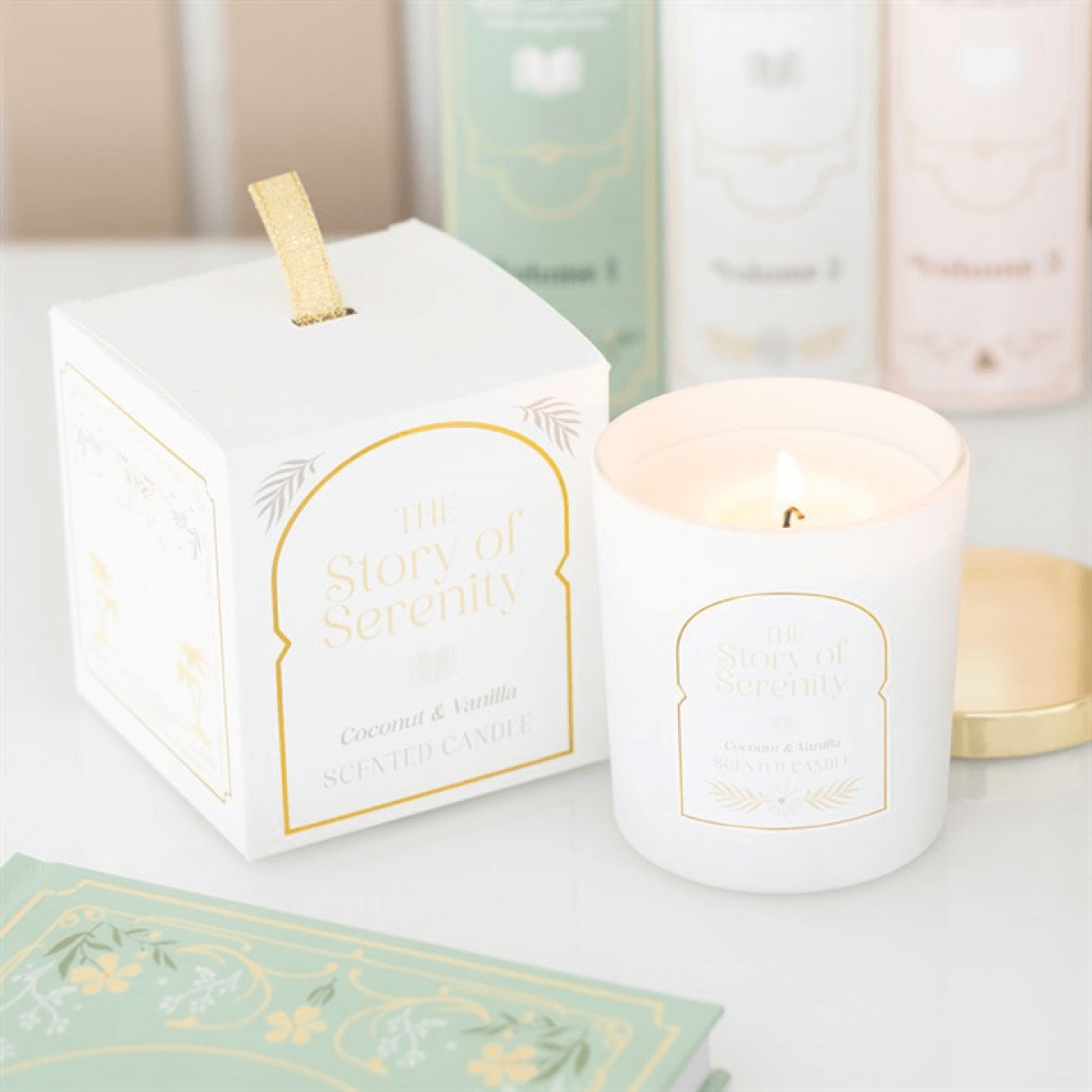 The Story Of Serenity Coconut And Vanilla Scented Candle in white jar with gold lid and gift box.