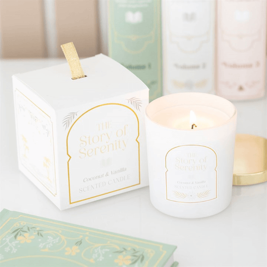 The Story Of Serenity Coconut And Vanilla Scented Candle in white jar with gold lid and gift box.