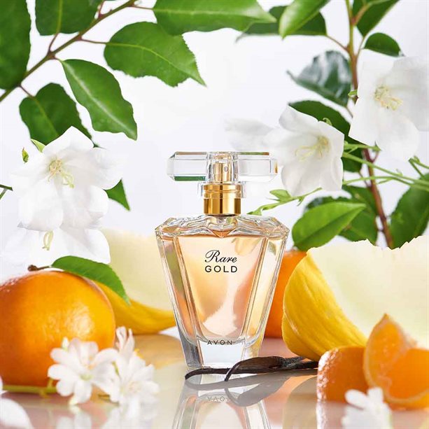 Rare Gold EDP - Luxurious Floral Perfume for All-Day Wear, elegantly presented with fresh flowers and citrus fruits.
