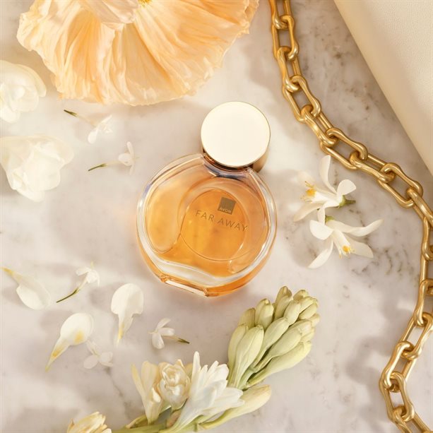 Avon Far Away Eau de Parfum surrounded by delicate flowers, capturing the essence of an extraordinary oriental fragrance.