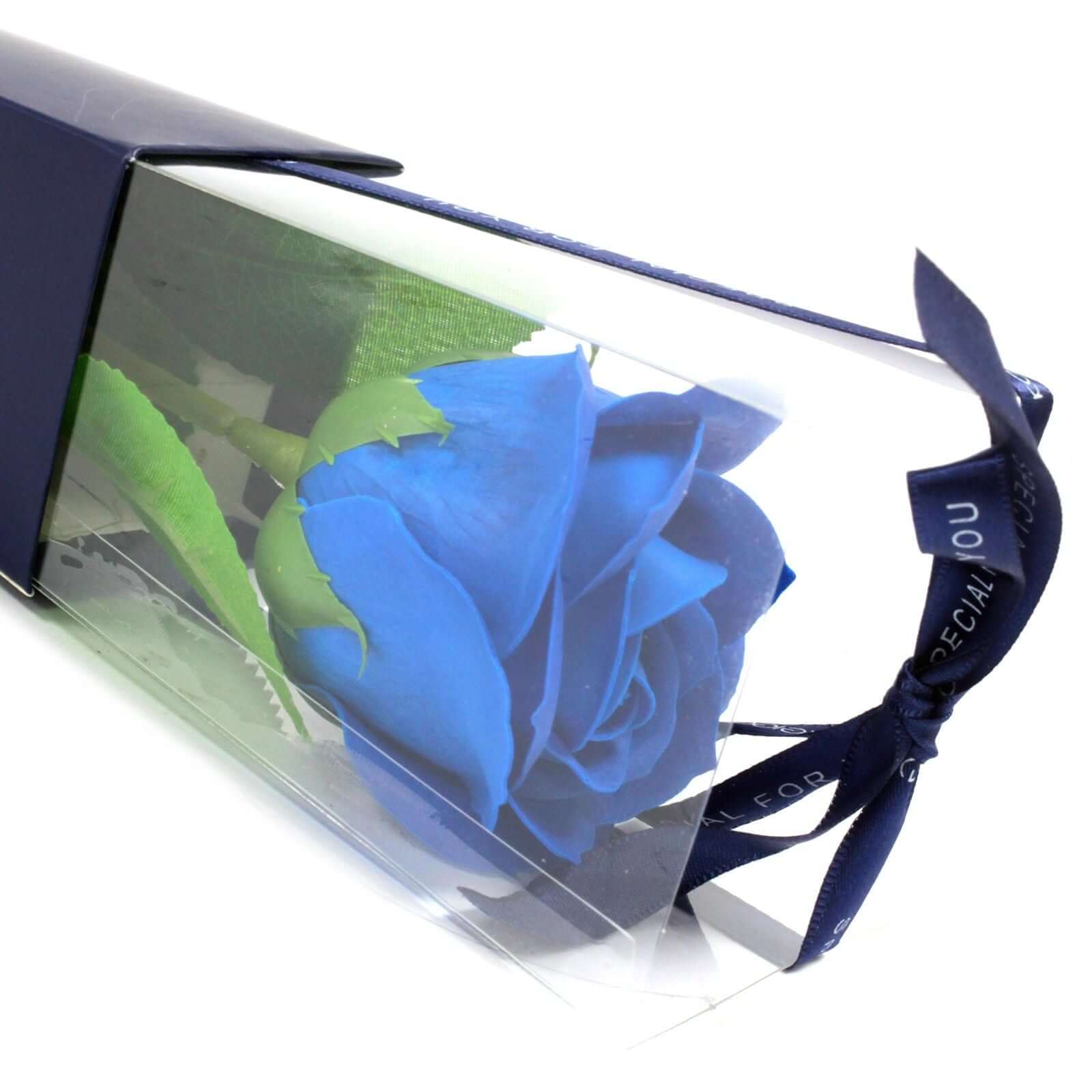 Single Rose - Blue Rose in elegant packaging showcasing vibrant deep blue color and lush green leaves.
