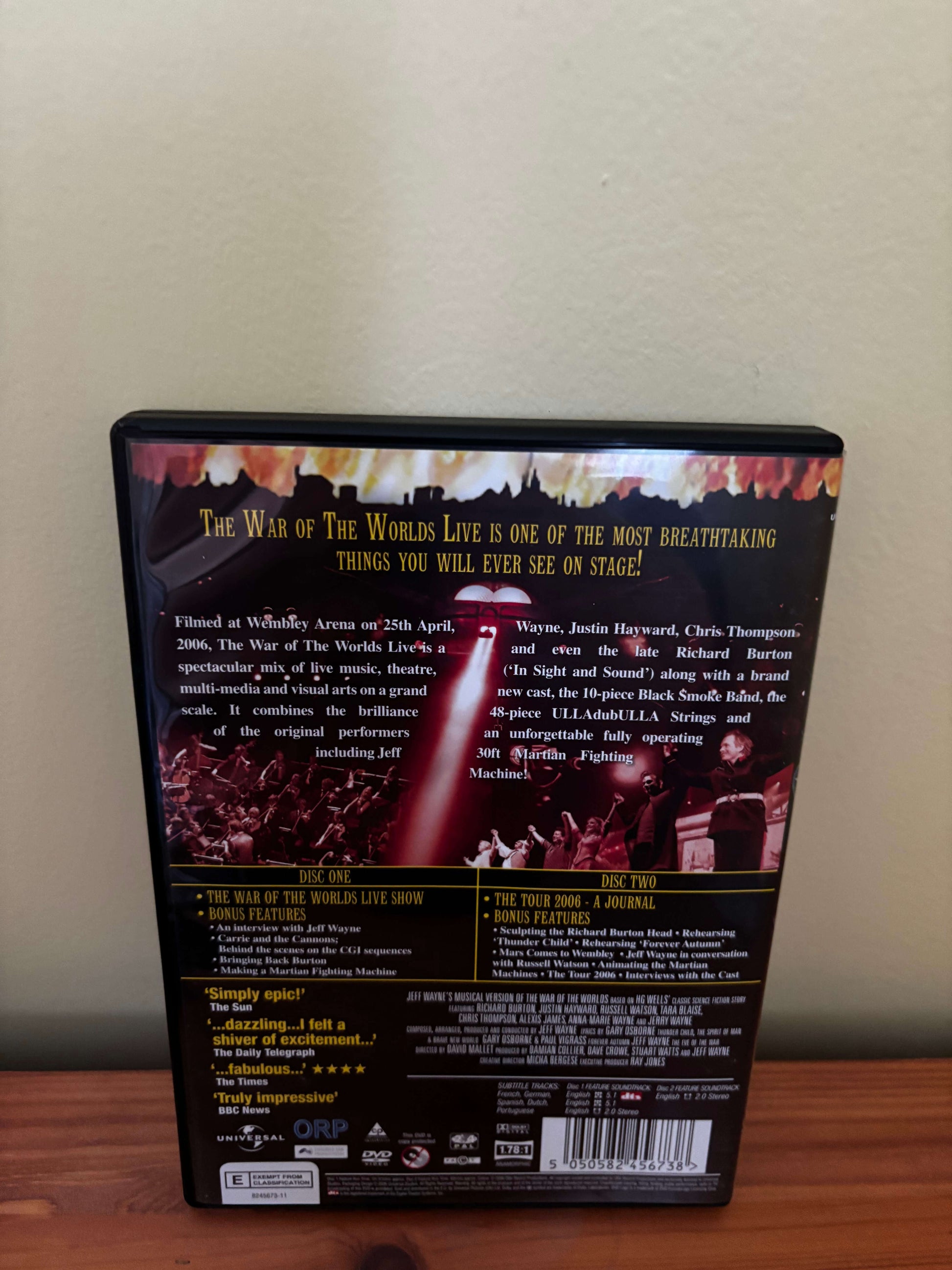 Back cover of a DVD with text and images on a wooden surface
