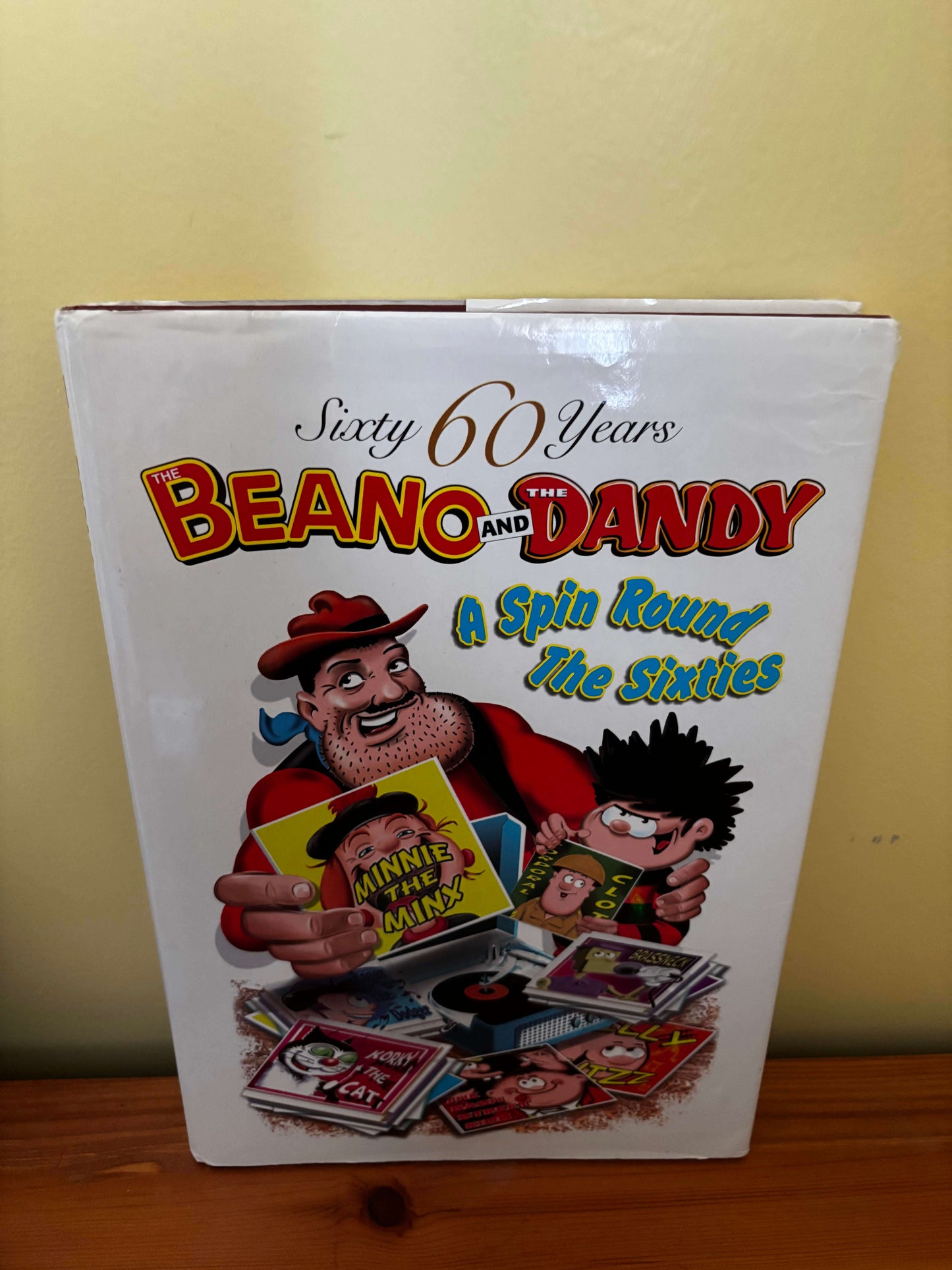 Book cover celebrating 60 years of Beano and Dandy with colorful illustrations on a white background.